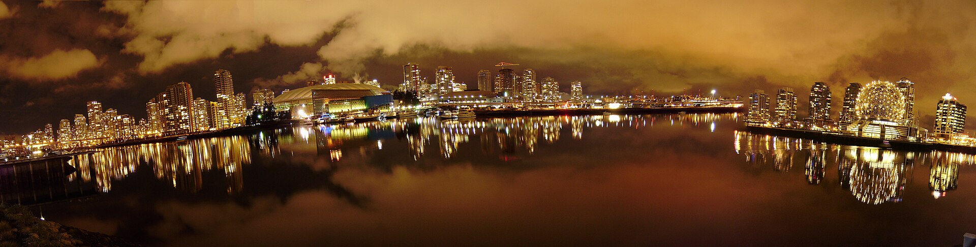 False Creek glowing at night, with the city lights reflected in the water
